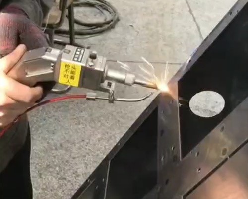 Operator Using Handheld Laser Welder Operator Using Handheld Laser Welder
